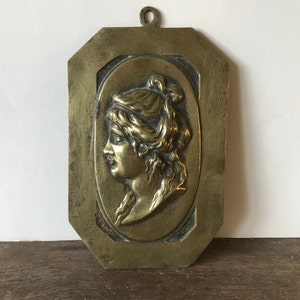 Brass medallion with brass female profile