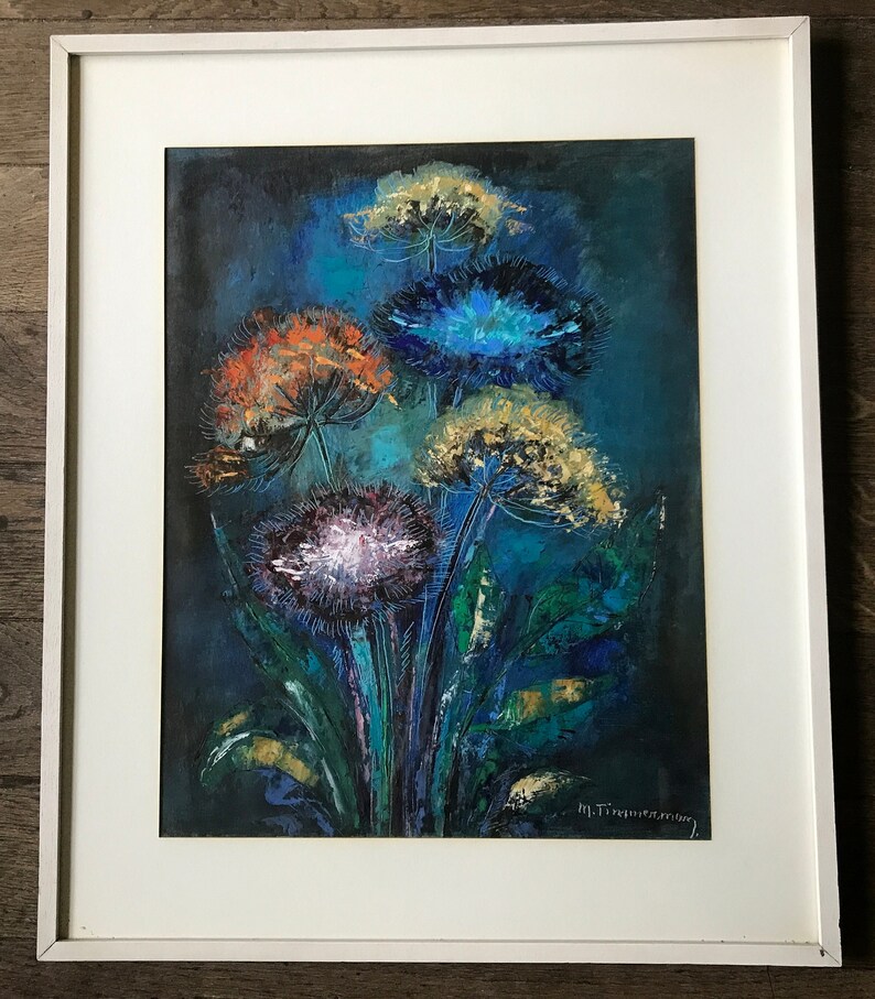 May include: A framed abstract painting of a bouquet of colorful flowers with blue, yellow, orange, and white petals on a dark blue background. The painting is signed "M. Tisserant".