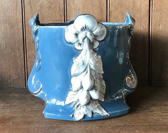 Blue earthenware planter with white flowers in relief, majolica