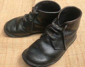 Pair of first toddler shoes , shoes covered in copper, decorative shoes