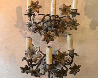Bronze and metal wall sconces, antique church ornaments. Floral decoration
