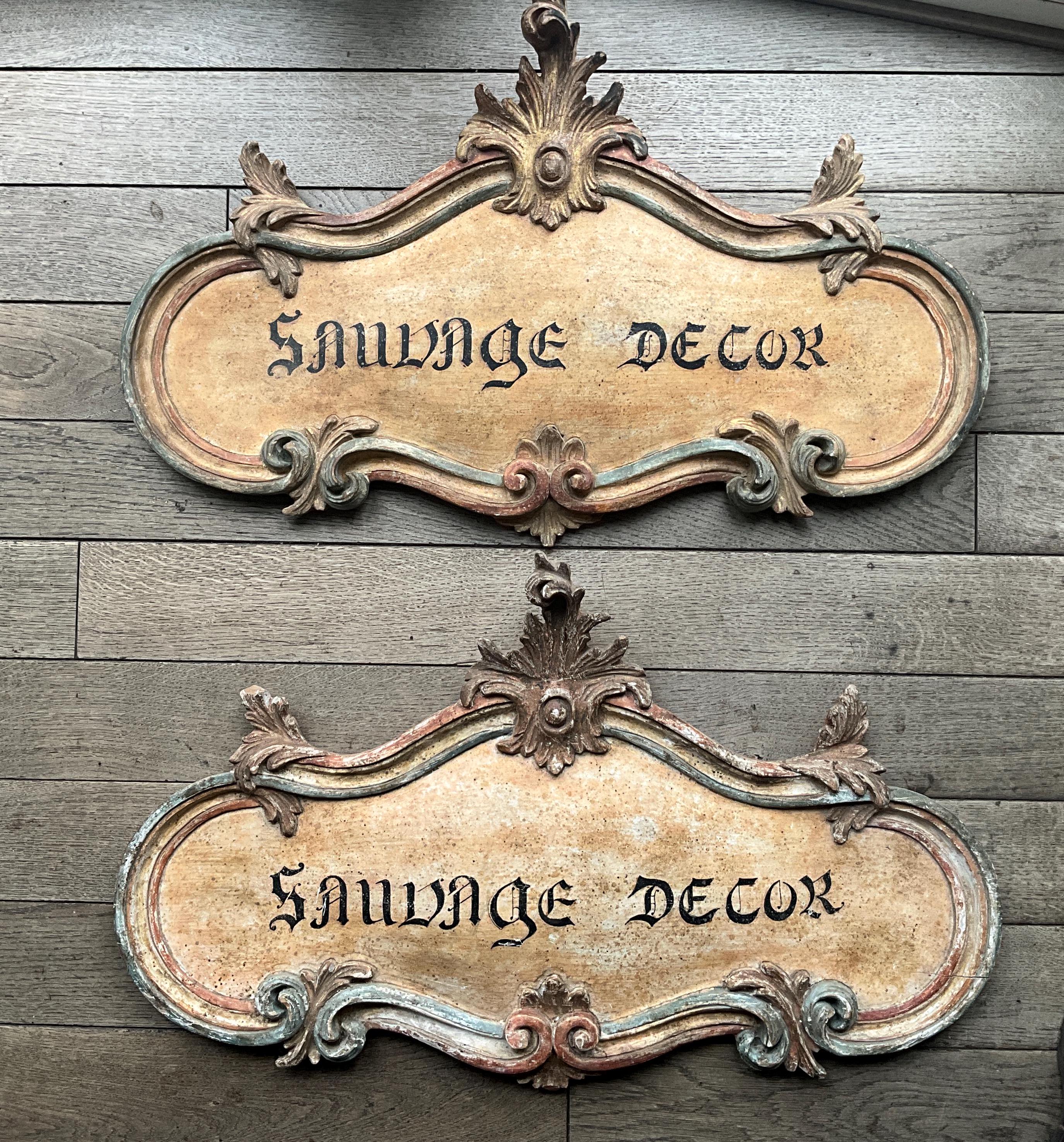 Old carved and painted wooden shop signs