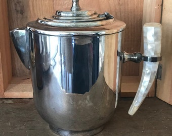 Silvered metal tea pot with mother-of-pearl handle