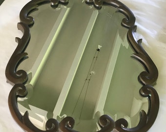 Bevelled mirror with brass frame
