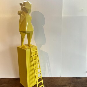 Decorative object in wood and yellow paint little girl with bouquet of flowers on a base with a ladder