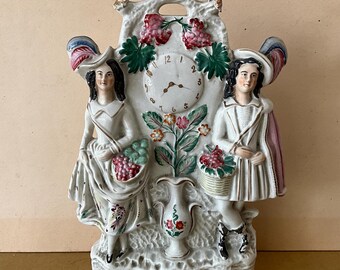 Staffordshire faience figurine, 19th century, Scottish couple with clock