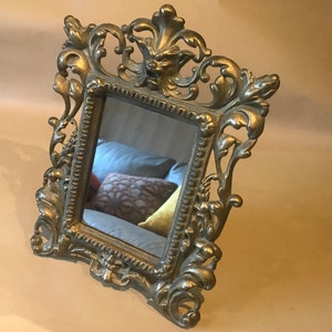 Gilt bronze frame on foot with mirror