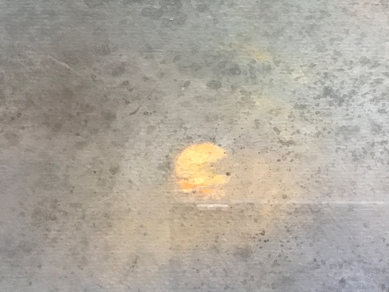 May include: A blurry, out-of-focus image of a sunset through a window with a textured glass surface.