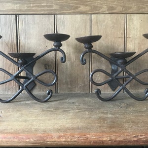 Wall candle holders, pair of wrought iron candle holders, each with 3 candle holders