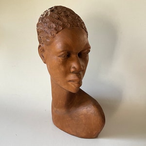 Head of an African woman in wood.