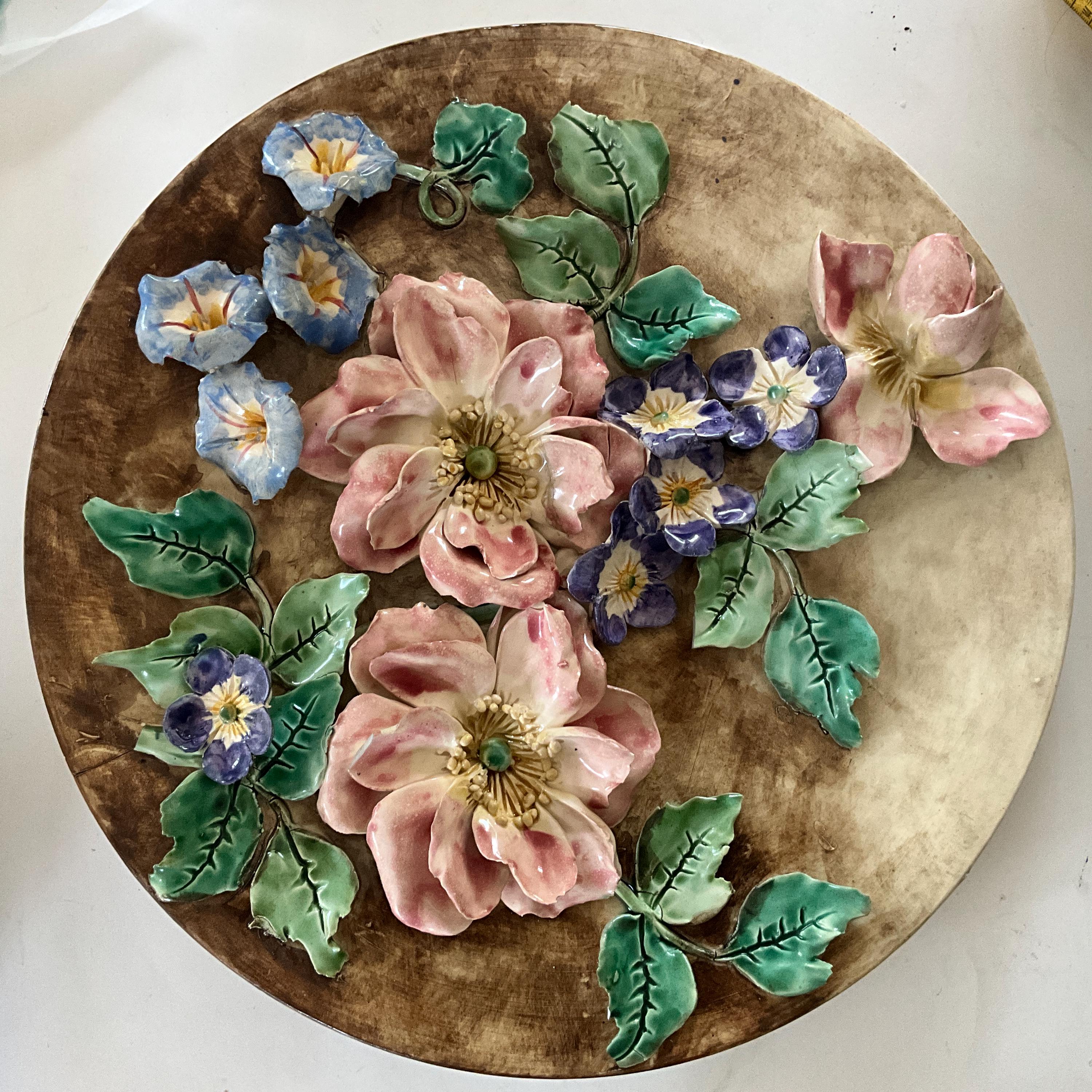 Large ironstone plate, Longchamp. Naturalist decoration of flowers in relief.