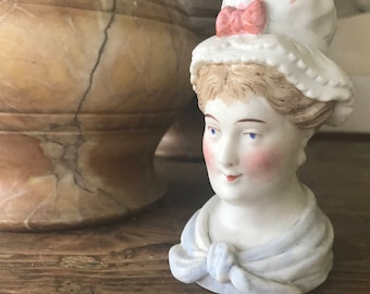 Little vintage china pot in the shape of a woman’s head with hat