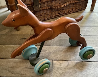 Antique toy, wooden dog on wheels to pull
