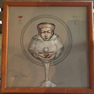 May include: A painting of a person wearing a white hat, enclosed within a glass goblet. The person is holding a small white object in their hands. The painting is framed in a wooden frame.