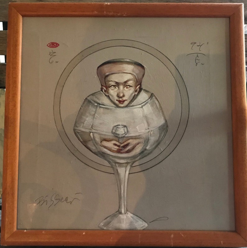 May include: A painting of a person wearing a white hat, enclosed within a glass goblet. The person is holding a small white object in their hands. The painting is framed in a wooden frame.