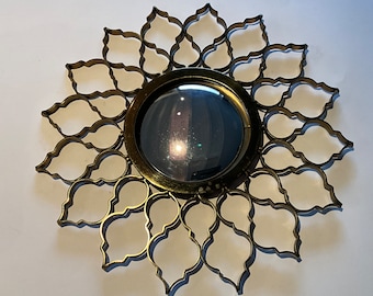 Convex mirror with metal openwork frame.