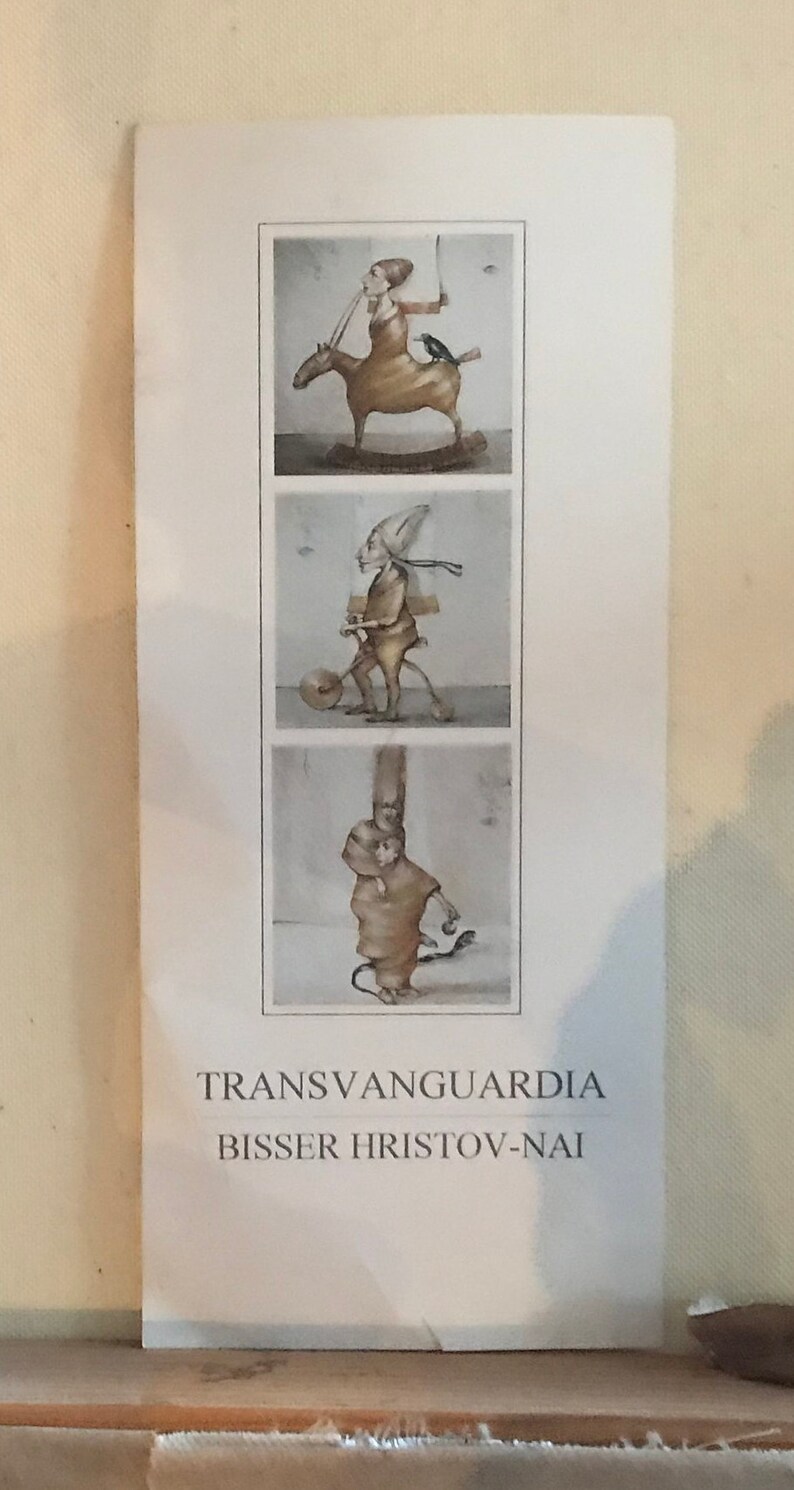 May include: A white poster featuring three black and white illustrations of figures. The poster has the text "Transvanguardia" and "BISSER HRISTOV-NAI" printed on it.
