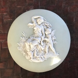 probably Wedgwood Small round green china plate with antique decor of a woman with angel