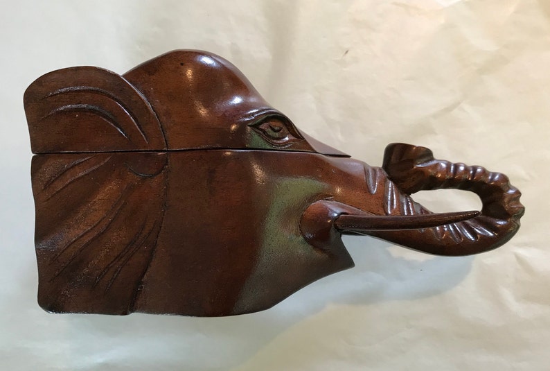 Elephant\u2019s head shaped carved wood box
