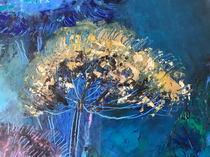 May include: Abstract painting with a large, white, and gold flower-like shape in the center. The flower is surrounded by blue and black brushstrokes on a dark blue background.