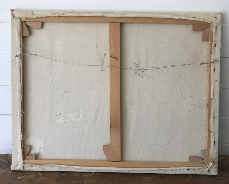 May include: The back of a canvas painting with a wooden frame. The canvas is white and has a few small brown marks. The frame is made of natural wood and has a few small scratches. The painting is signed "H. Paul" and dated "2002".