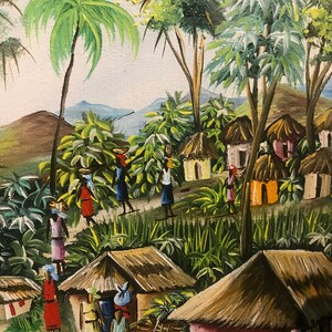 May include: A colorful painting depicting a village scene in a tropical setting. The painting features lush green foliage, palm trees, and thatched-roof huts. There are several figures in the painting, some carrying baskets on their heads, walking along a path.