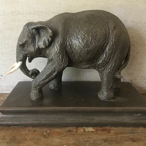 Beautiful baby elephant on base, all in resin