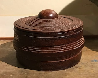 Round wooden box covered in leather