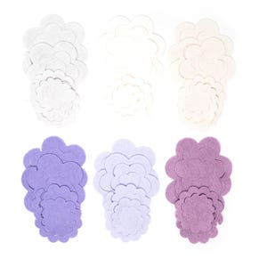May include: Six sets of felt flower shapes in white, lavender, and purple. Each set includes five flower shapes of varying sizes.