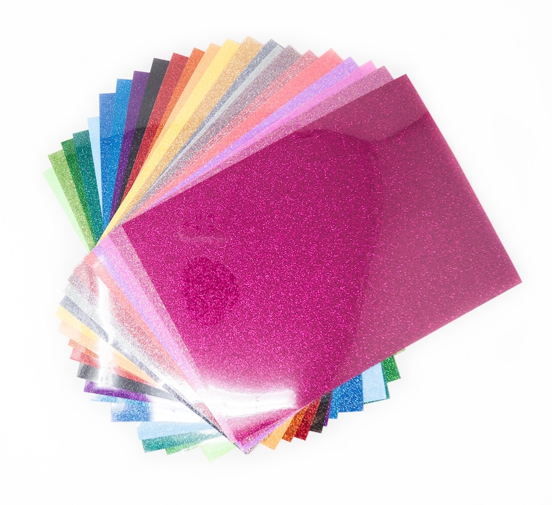 May include: A selection of glitter sheets in a range of colours, such as pink, green, blue, and silver. The sheets have a shiny, textured surface, and are arranged on a white background. Suitable for crafting and DIY projects.