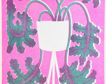 May include: A white ceramic planter with three legs, holding a leafy green plant with purple accents. The plant is set against a bright pink background.