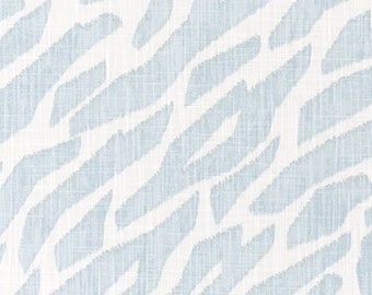 May include: A light blue and white patterned fabric. The design features diagonal, irregular shapes in light blue against a white background. The fabric has a textured appearance, suggesting a linen or similar weave. This textile is suitable for various home decor projects.