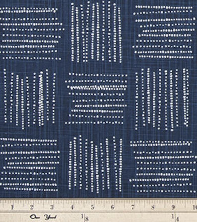 May include: Navy blue fabric with a white geometric pattern of small dots arranged in vertical lines and squares. The fabric has a subtle linen texture.