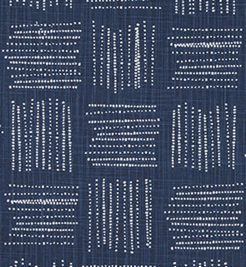 May include: A navy blue fabric with a white geometric pattern of dots and lines. The pattern is repeated throughout the fabric.
