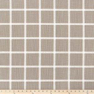 May include: Tan fabric featuring a white grid design. The fabric has a textured look, with white lines forming a grid of squares. A wooden ruler at the bottom measures up to 84 cm.