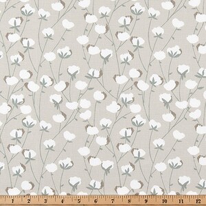 May include: A beige fabric with a repeating pattern of white cotton blossoms and green stems.