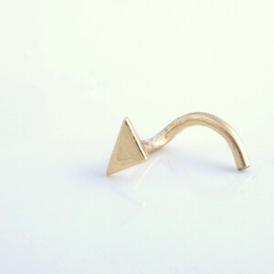 May include: A gold triangle nose ring with a curved post.