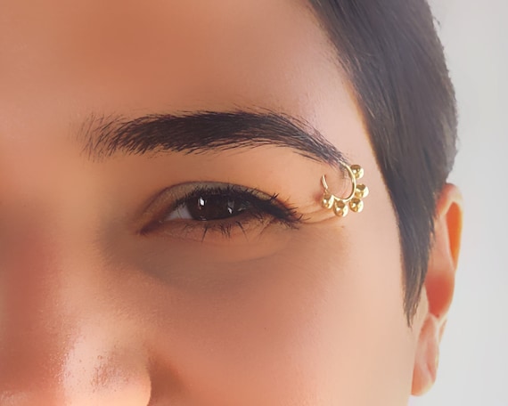 Gold eyebrow piercing discount