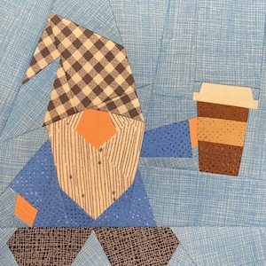 May include: A blue and white gnome holding a brown and beige coffee cup. The gnome has a black and white checkered hat and a striped shirt.