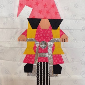May include: A pink and yellow gnome wearing sunglasses and riding a silver bicycle with black and white striped wheels.