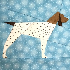 May include: A white and brown patchwork dog with black spots, standing on a blue background with white stars.