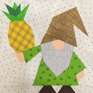 May include: A green gnome with a brown hat holds a yellow pineapple with green leaves. The gnome is wearing a green shirt with white polka dots and a white beard. The background is white with green polka dots.