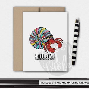 May include: A colorful greeting card with a cartoon hermit crab in a shell. The text on the card reads "Shell Yeah! Congrats on your new home".