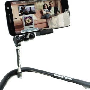 May include: A black phone holder with a flexible arm and a base that can be adjusted to different angles. The phone holder is attached to a black stand with the word "CamStand" printed on it. A smartphone is mounted in the holder and is displaying a video on the screen.