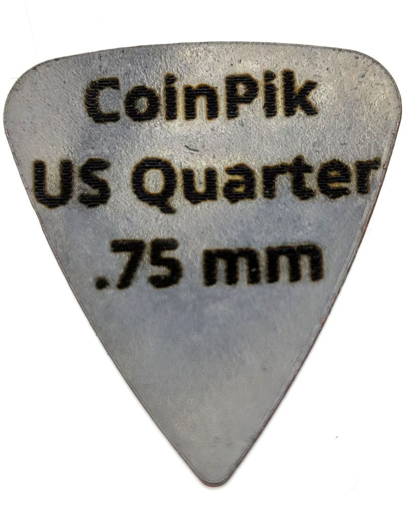 K&ouml;nnte beinhalten: Ein dreieckiges, silberfarbenes Plektrum aus einem US-Quarter. Die Oberfl&auml;che ist mit dunklem, eingraviertem Text versehen, der CoinPik, US Quarter und .75 mm lautet und die Dicke des f&uuml;r dieses Musikzubeh&ouml;r verwendete Metall angibt.