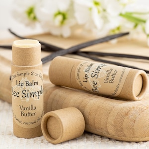 May include: Three brown cardboard tubes with white labels. The labels read "Bee Simple 2 on Etsy", "Lip Balm", "Bee Simple", "Vanilla Butter", "Shea butter, coconut oil, and", "Bee Simple 2 on", "Lip Balm", "Bee Simple", "Vanilla Butter", "Shea butter, coconut oil".