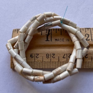 5002 5x3mm white tube wampum quahog beads 16” strand. About 78 beads.