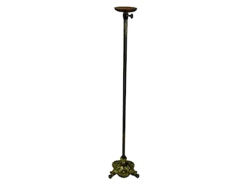 May include: A tall, adjustable, gold-toned metal stand with a wooden top. The stand has a decorative base with three legs.