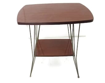 May include: A mid-century modern side table with a dark brown, rectangular top and a lower shelf. The table has thin, angled metal legs. The table is approximately 24 inches long, 16 inches wide, and 20 inches tall.