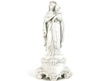 May include: White porcelain statue of the Virgin Mary holding a baby Jesus. The statue is on a pedestal with ornate details.